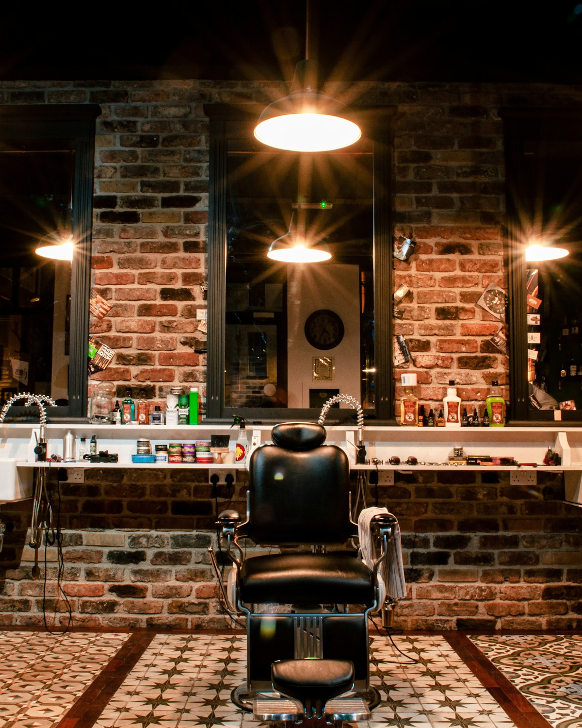 The shop's brick wall, the counter and the row of pendant lamps hanging over the chair